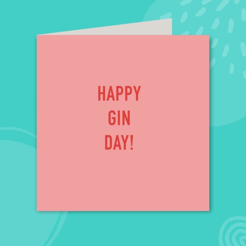 Image shows a pale pink greeting card with red text, on a teal background. The text on the card reads 