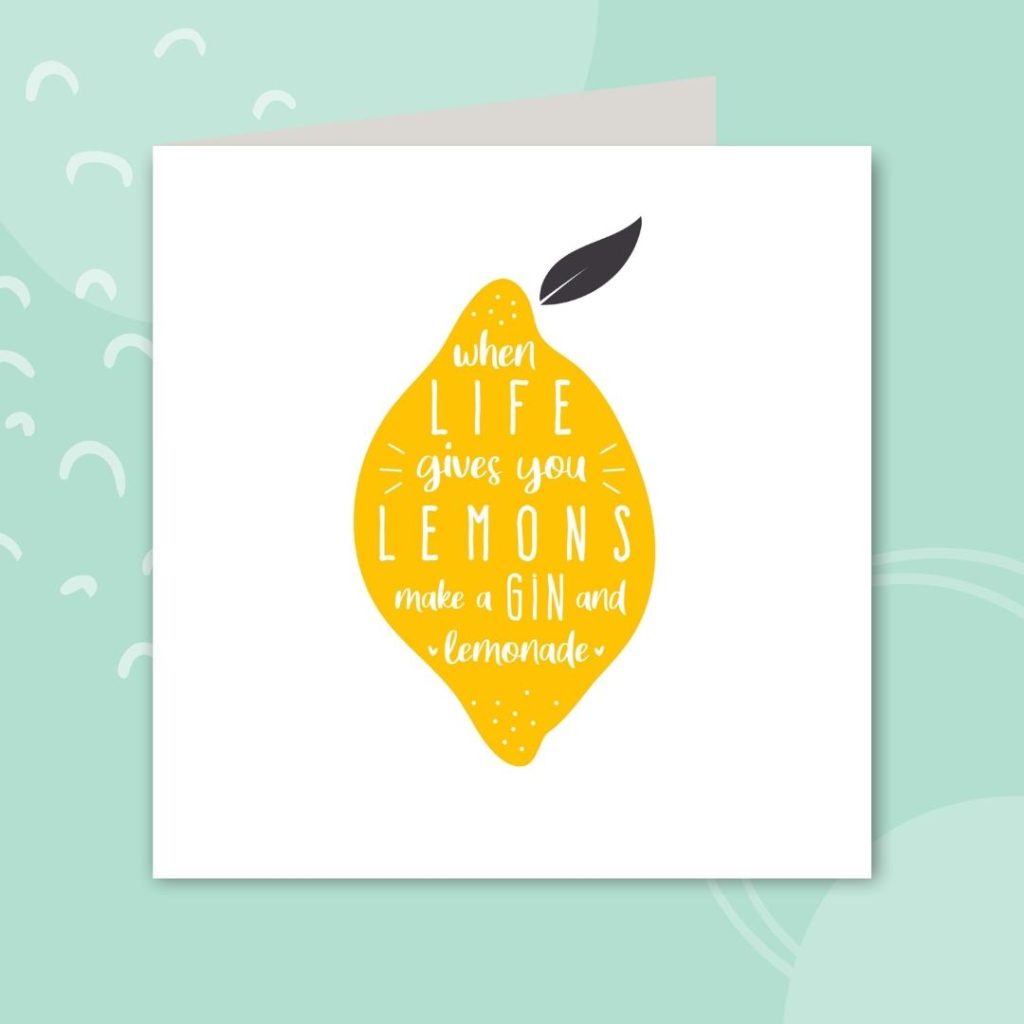 Image shows a white greeting card with a lemon illustration in the middle, over a pale mint background. The text on the card reads 