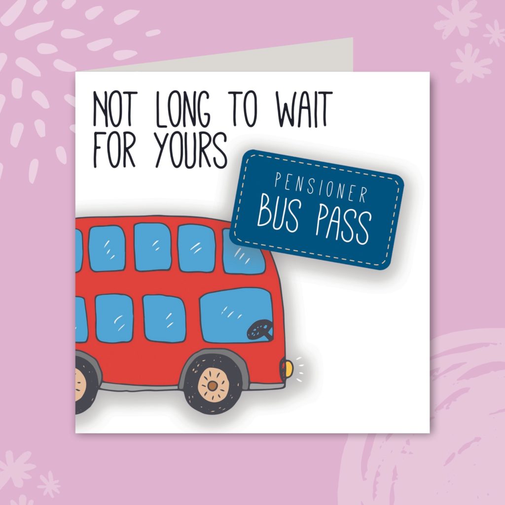 Image shows a greeting card on a pale purple background. The card is white with an illustration of a red double decker bus. Next to the bus is a blue bus pass that reads 