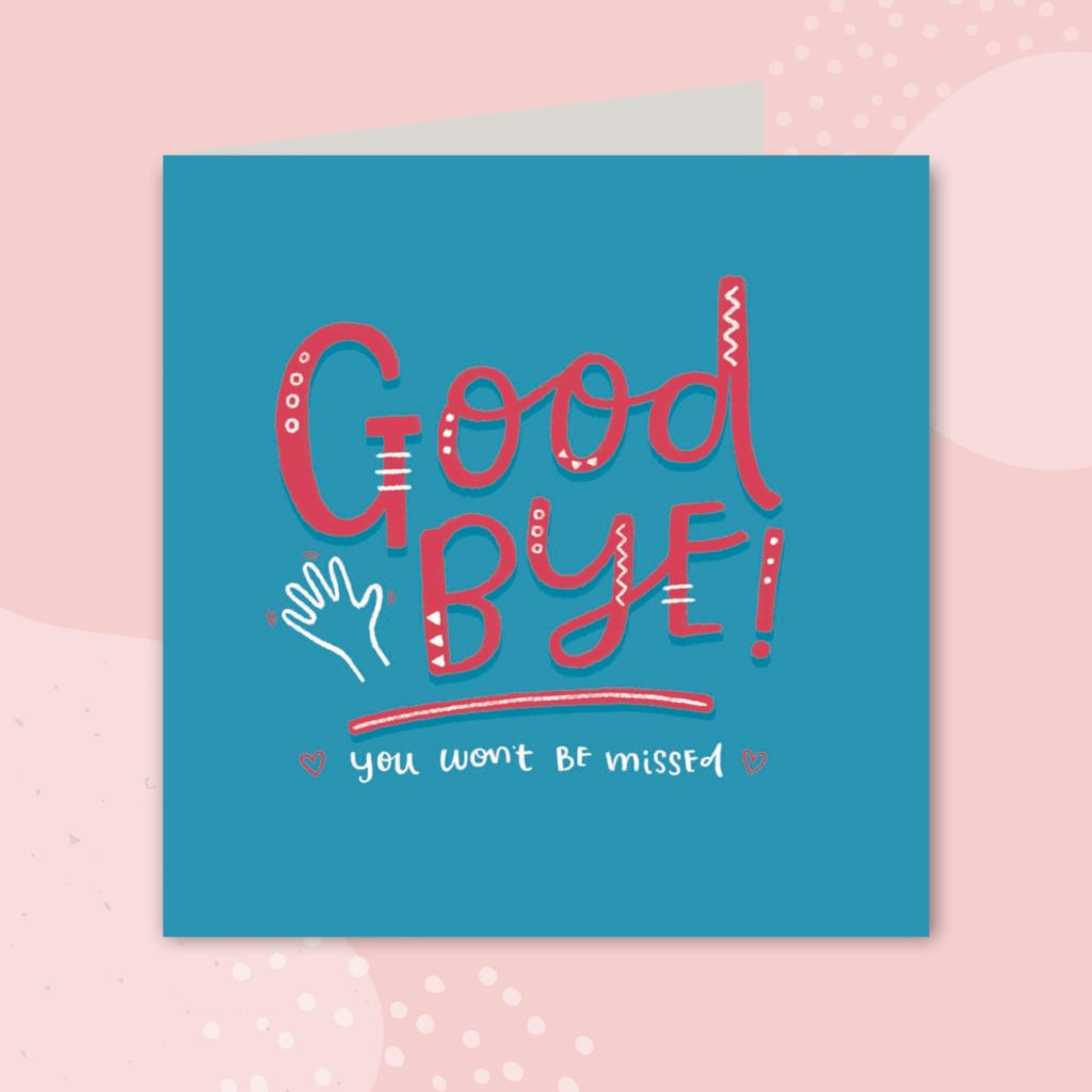 Image shows a greeting card on a pale pink background. The greeting card is blue and has red and white text in the center. The red text reads 